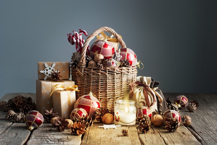 Christmas basket with ornaments, gifts, and candle