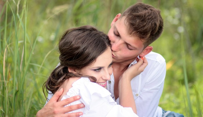 Couple in love kissing in a field