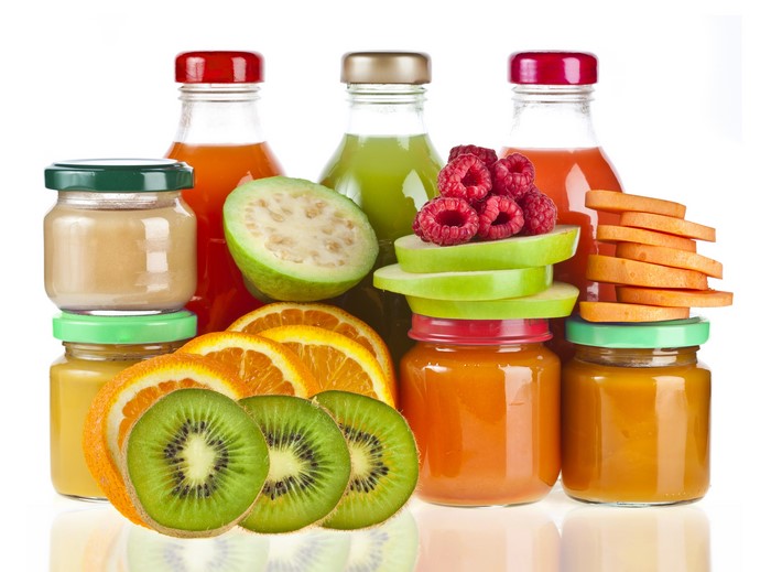 Juice bottles and jars with fruits and vegetables