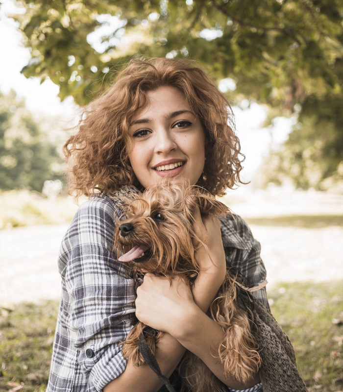 Woman holding a Yorkshire Terrier dog