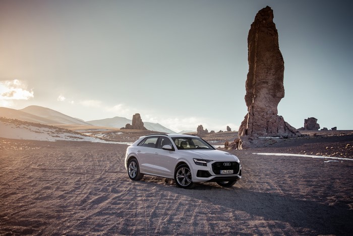 White Audi Q8 in a rocky desert landscape