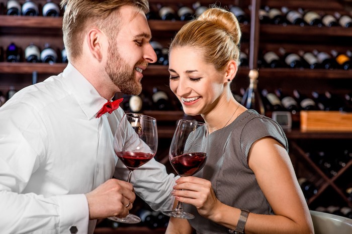 Couple enjoying red wine in a wine cellar