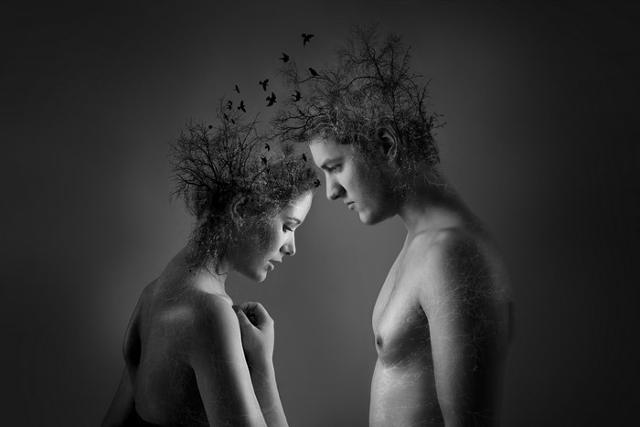 Man and woman with trees and birds on heads
