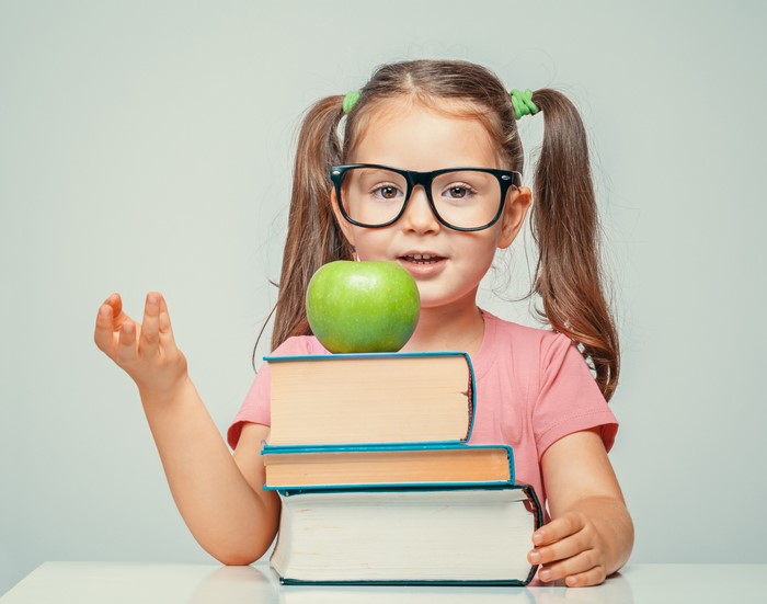 Little Girl with Glasses and Books