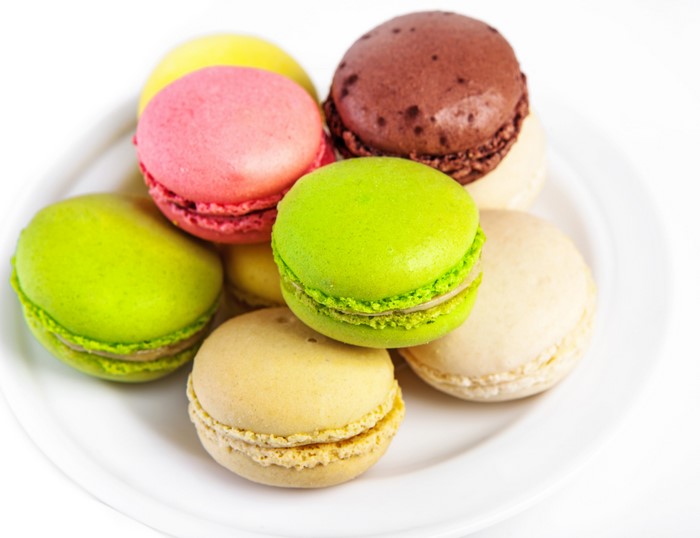 Assortment of colorful macarons on a white plate
