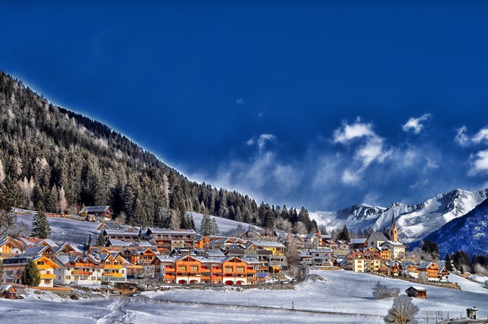 Winter village in the Alps with snow-covered mountains