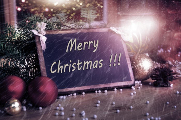 Merry Christmas chalkboard with ornaments and pine branches