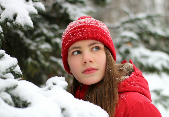 Girl in red hat and jacket in the snow