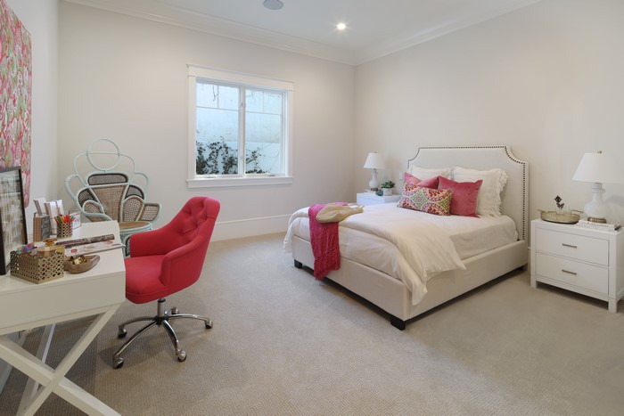 Bedroom with a bed, desk, and chairs