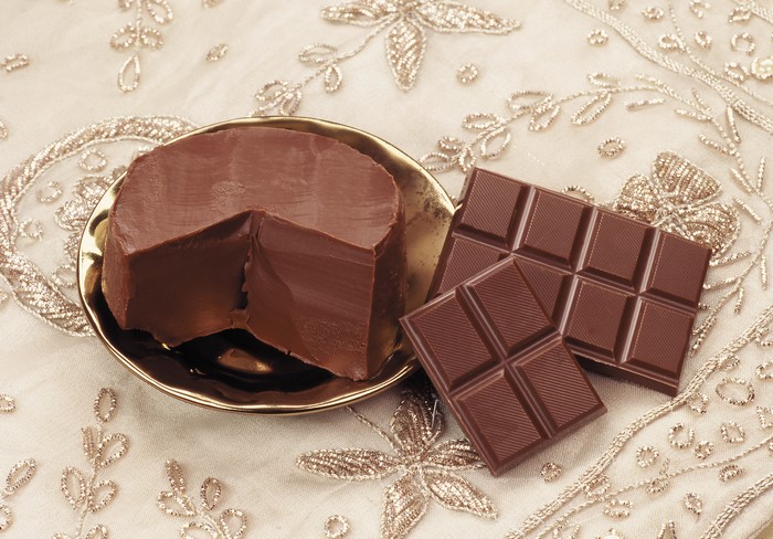 Chocolate cake and chocolate bars on a decorative cloth