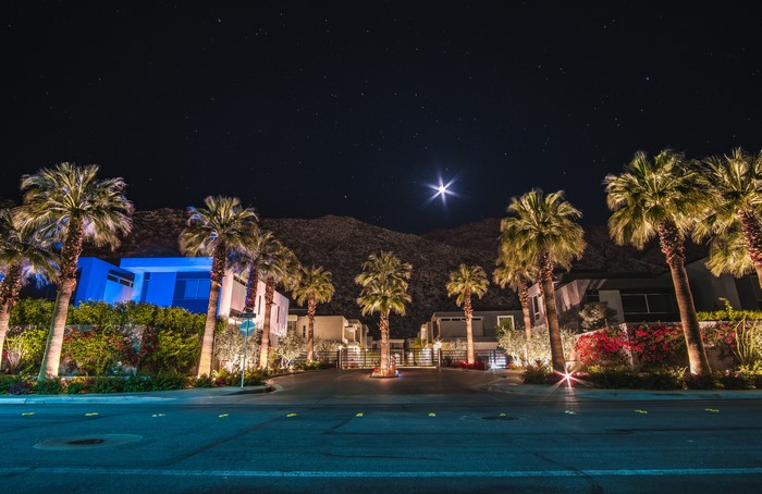 Modern houses and palm trees at night in California