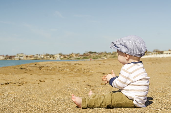 Baby boy sitting on a beach