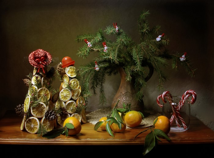 Christmas still-life with oranges, candy canes, and pine cones