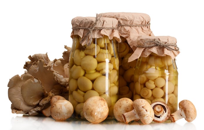 Jars of Pickled Mushrooms with Fresh Mushrooms