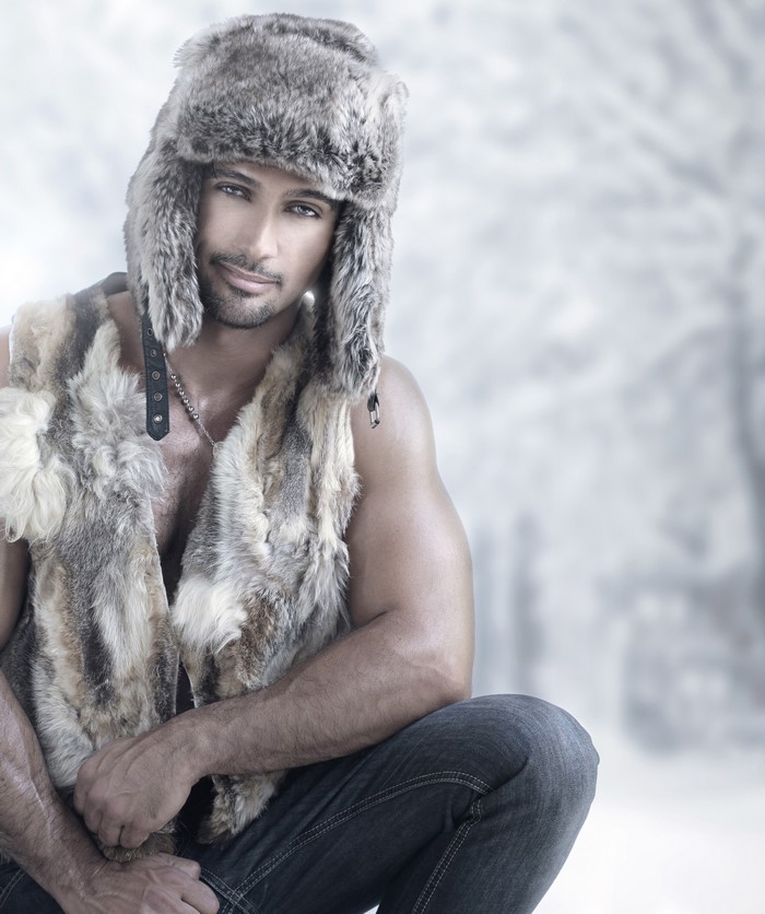 Man in fur hat and vest in winter setting