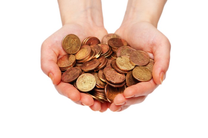 Hands holding a pile of coins