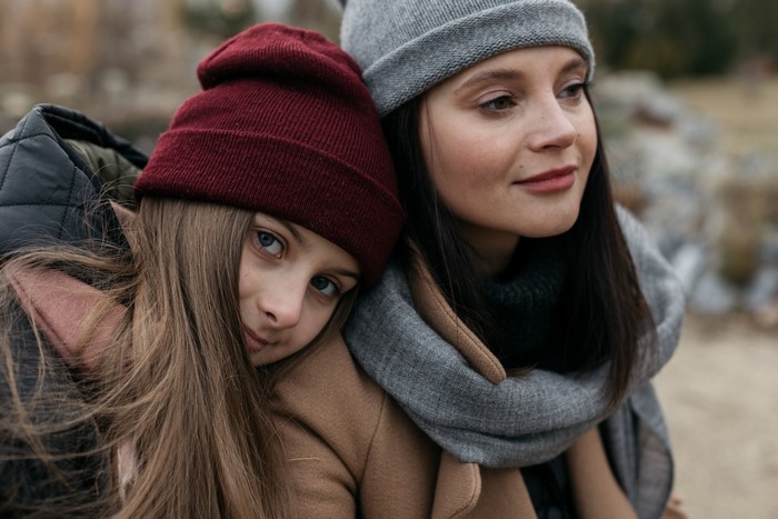 Two girls wearing winter hats and coats