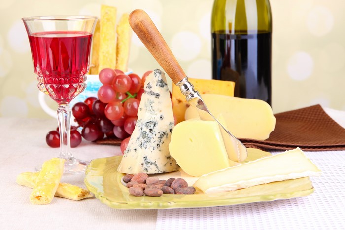 Wine and cheese still life with grapes and nuts