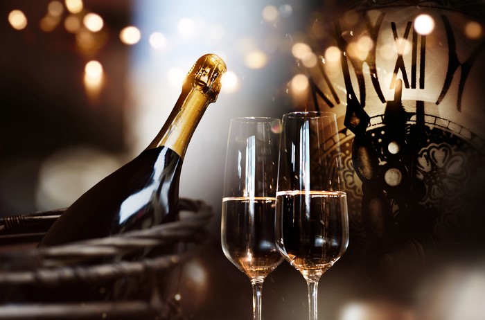 Champagne bottle and glasses with clock