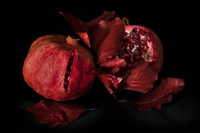 4K Pomegranate with Foliage on Black Background