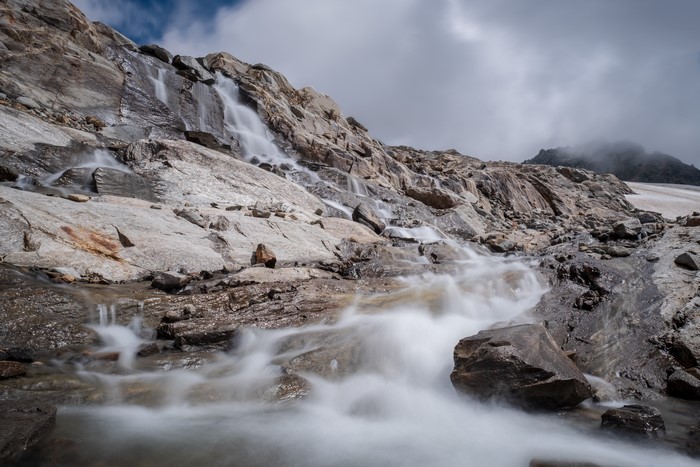 Waterfall cascading over rocky mountain slope