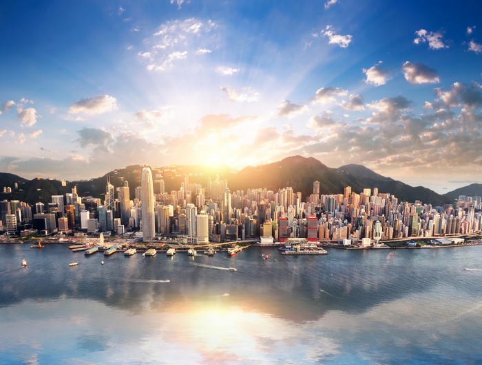 Hong Kong skyline at sunrise with mountains and sea