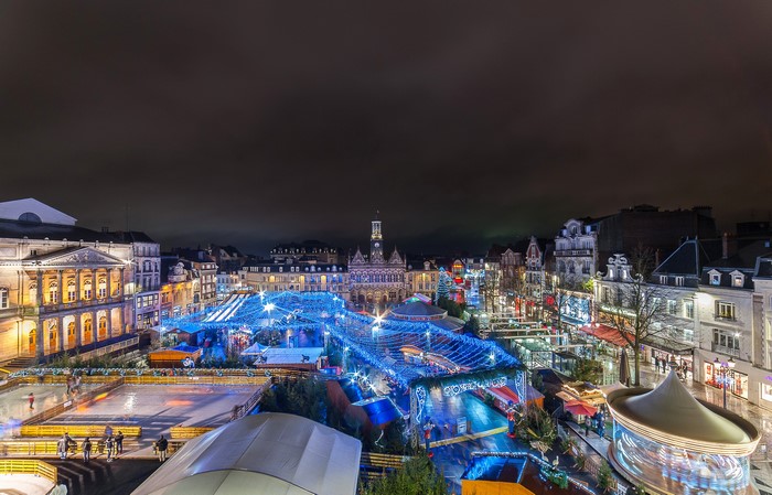 Christmas market and ice rink in Saint Quentin, France at night