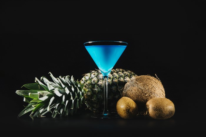 Blue Cocktail with Pineapple, Coconuts, and Kiwis
