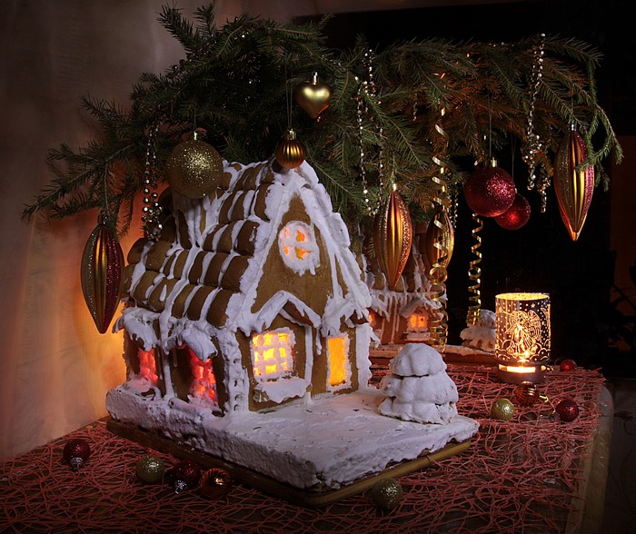 Gingerbread houses decorated for Christmas with ornaments and pine branches
