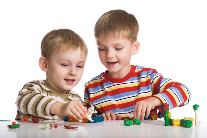 Two Boys Playing with Clay
