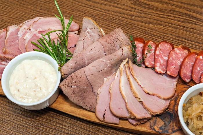 Meat platter with various cold cuts and dips