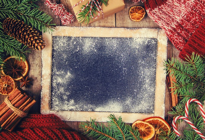 Christmas chalkboard with pine cones and cinnamon