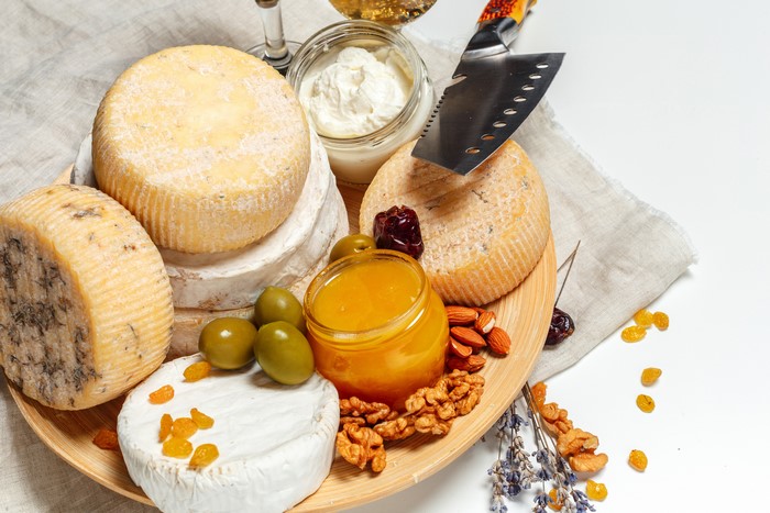 Cheese platter with nuts, olives, and honey