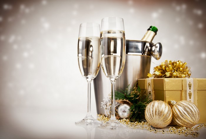 Champagne glasses with Christmas decorations and gifts