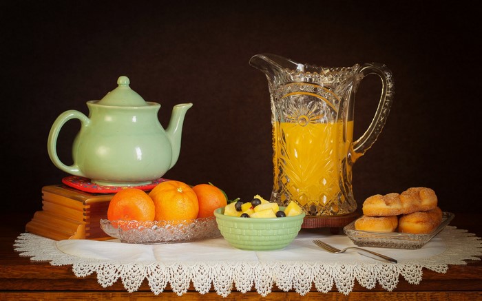 Still life with oranges, pastries, and juice
