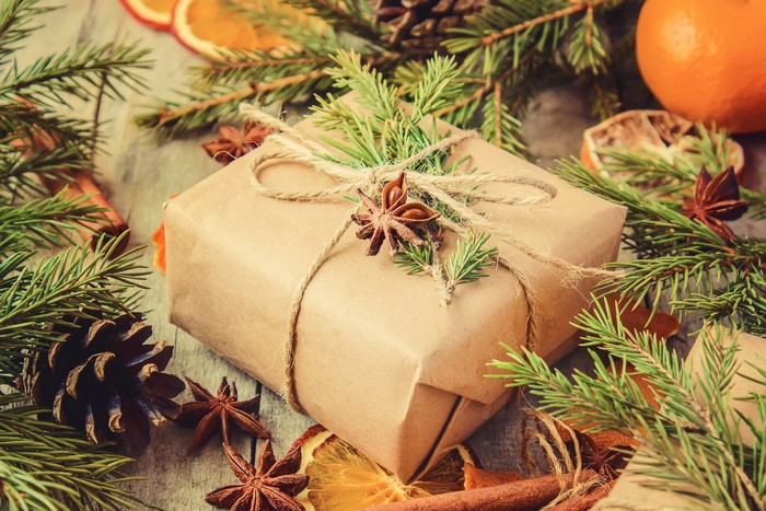 Christmas gift wrapped in brown paper with pine branches and star anise