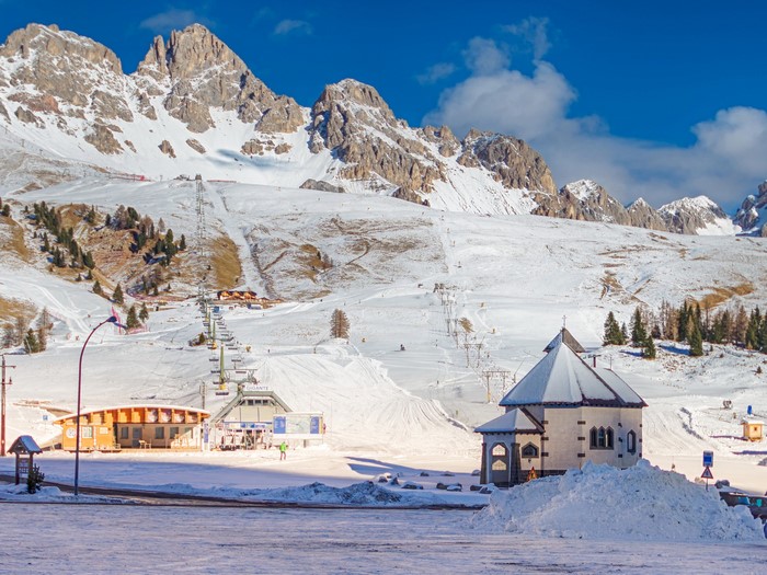 Ski resort with mountains and chapel in San Pellegrino, Italy