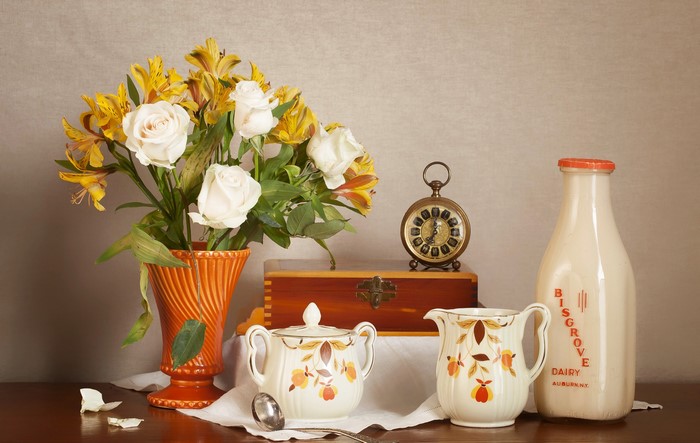 Still-life with roses, alstroemeria, milk bottle, and clock
