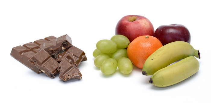 Chocolate bar with apples, grapes, orange, and bananas