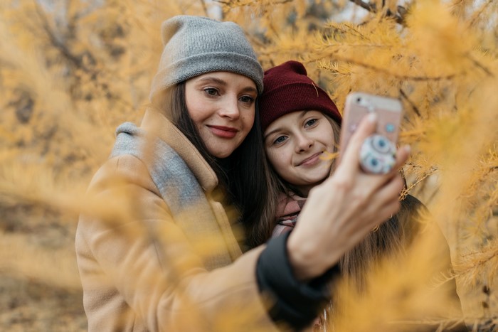 Two women taking a selfie in autumn