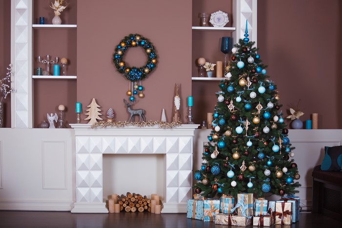Christmas interior with tree, fireplace, and gifts