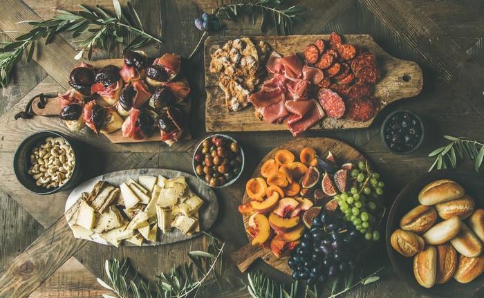 Charcuterie board with meats, cheeses, fruits, and nuts