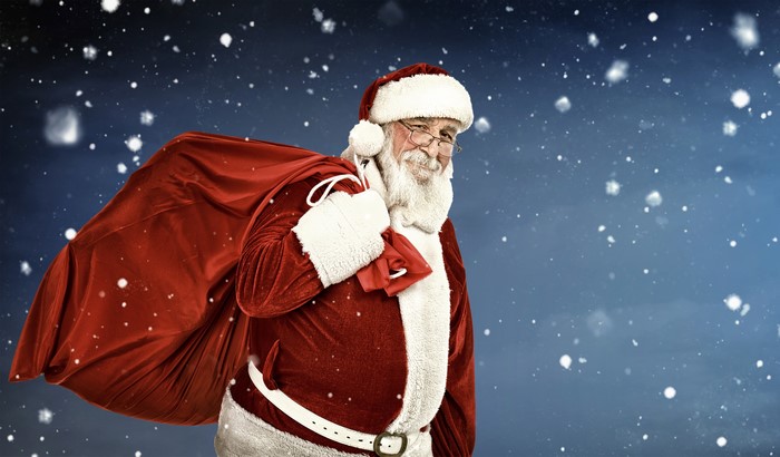 Santa Claus with a sack of gifts in the snow
