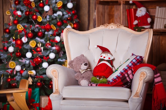 Christmas tree with armchair, teddy bear, and Santa Claus