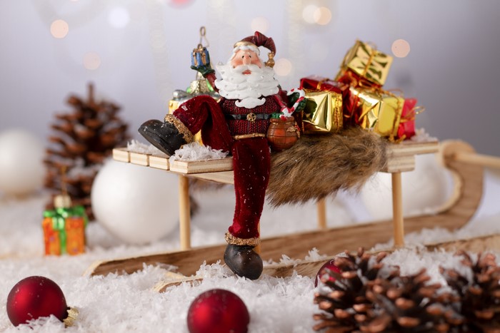 Santa Claus on a sled with gifts and ornaments