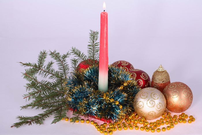 Christmas candle with ornaments and fir branches