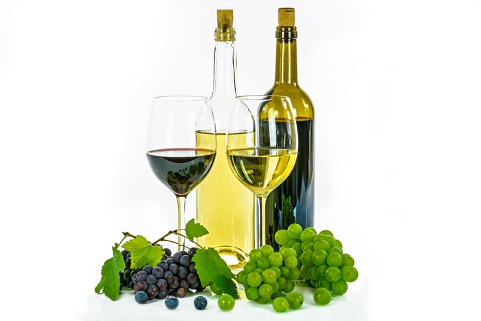 Wine bottles and glasses with grapes