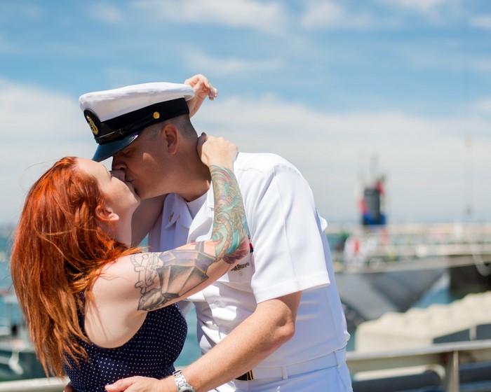 Couple kissing, man in Navy uniform