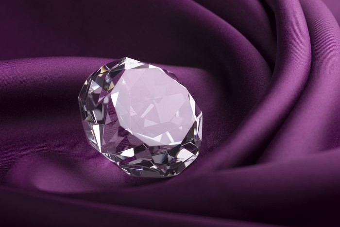 Brilliant diamond on purple silk
