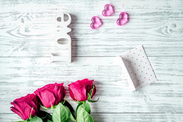 Valentine's Day arrangement with roses and love sign